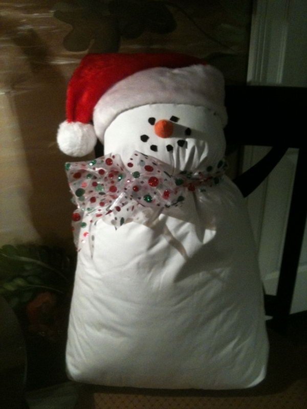 snowman from bed pillow and a santa hat